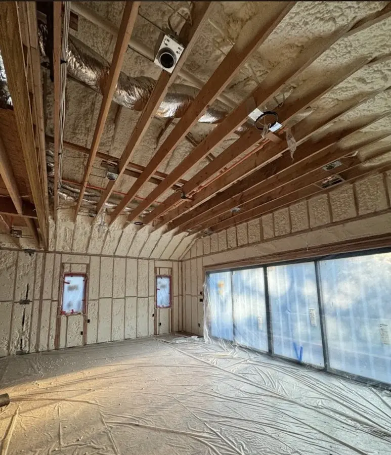 Interior walls and ceiling insulated with spray foam during new construction in East Rochester
